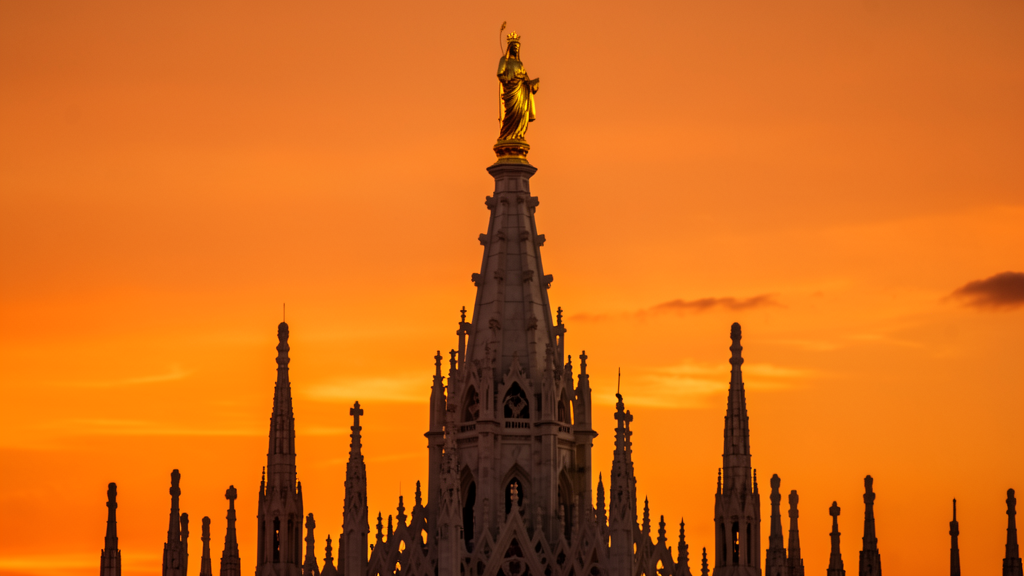 The gilded Madonnina statue on top of Duomo di Milano spire